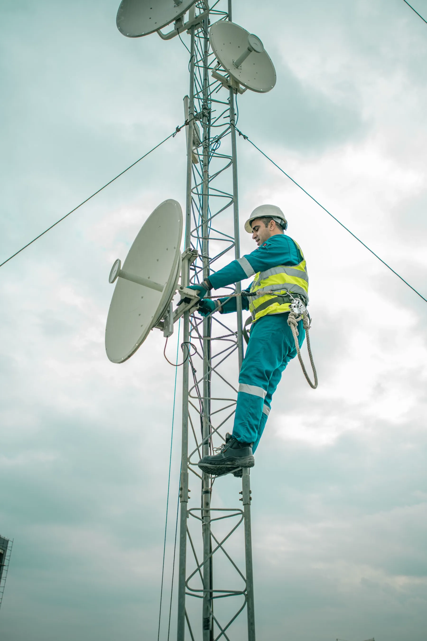 Field technician working on telecom tower equipment